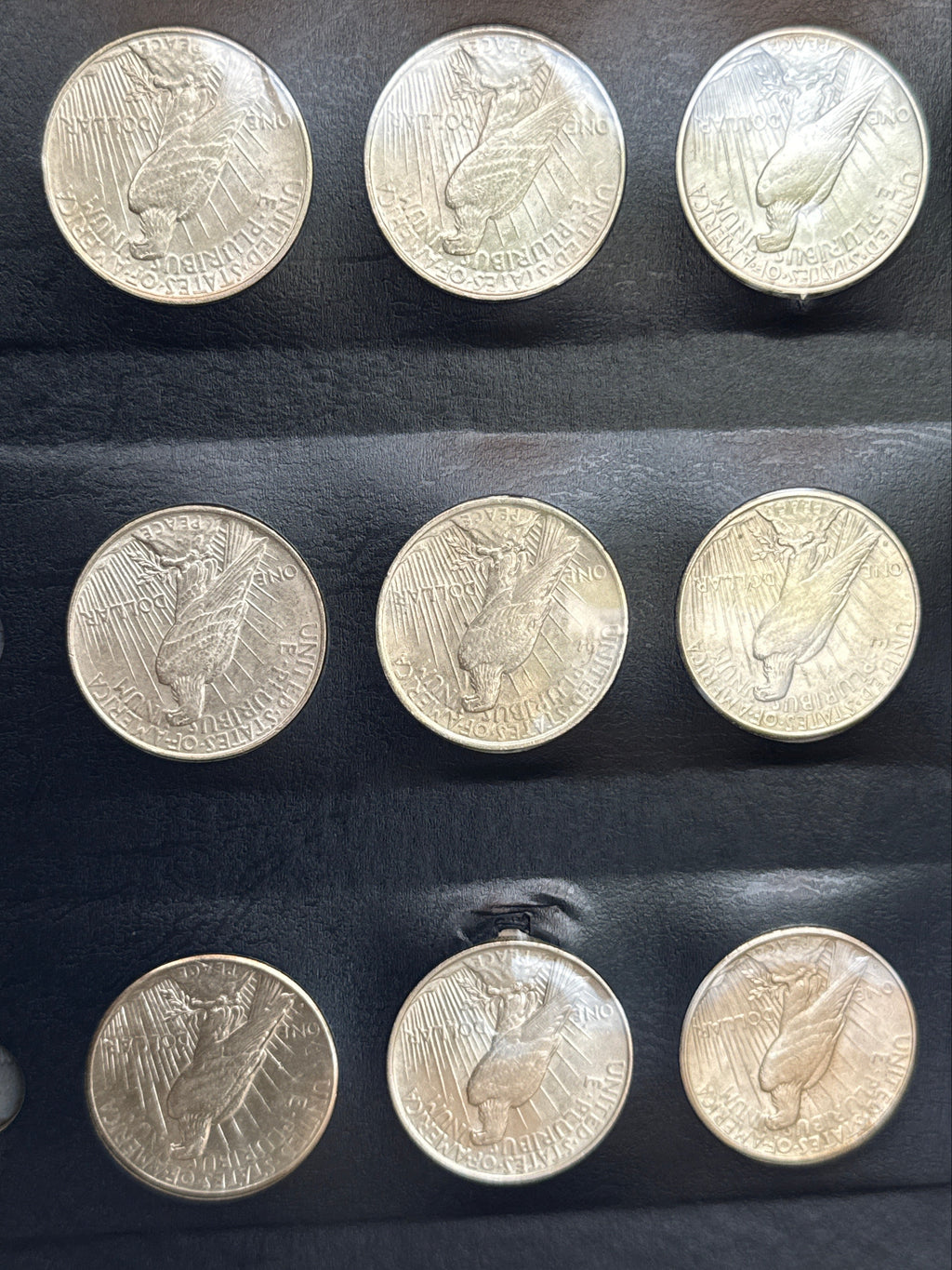 1921-1935-P,D&S American Silver Peace Dollar 24-Coin Set in Whitman Album  Mostly Uncirculated.